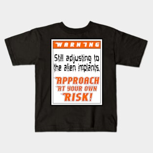 Warning: Still adjusting to the alien implants Kids T-Shirt